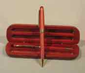 This is a image of a pen and pencil with a redwood box