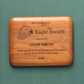 This is a image of a laser engraved walnut plaque with an elipitical edge and when selected will take the visitor to the plaques home page.