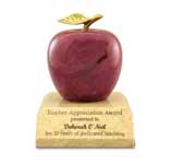 This is a image of a red marble apple on a base