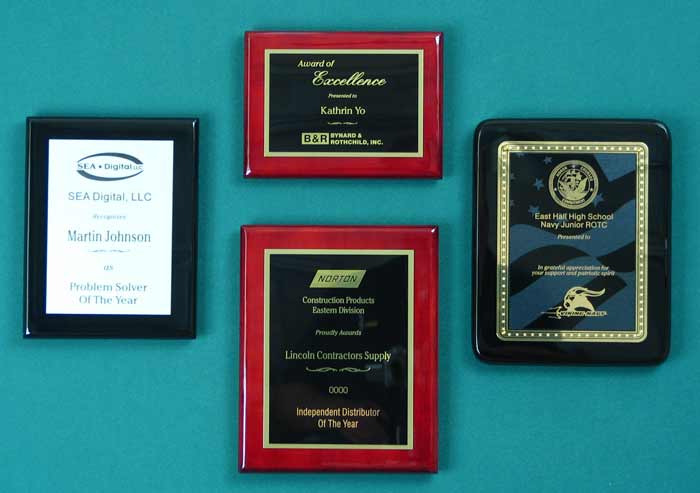 Image of four piano finish plaques